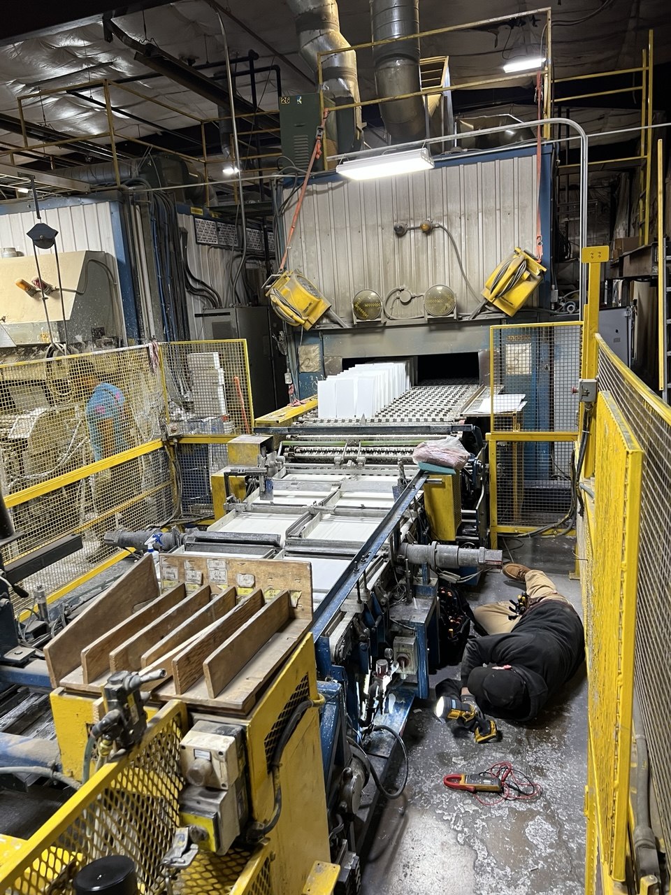 Wide view — technician at work under machine