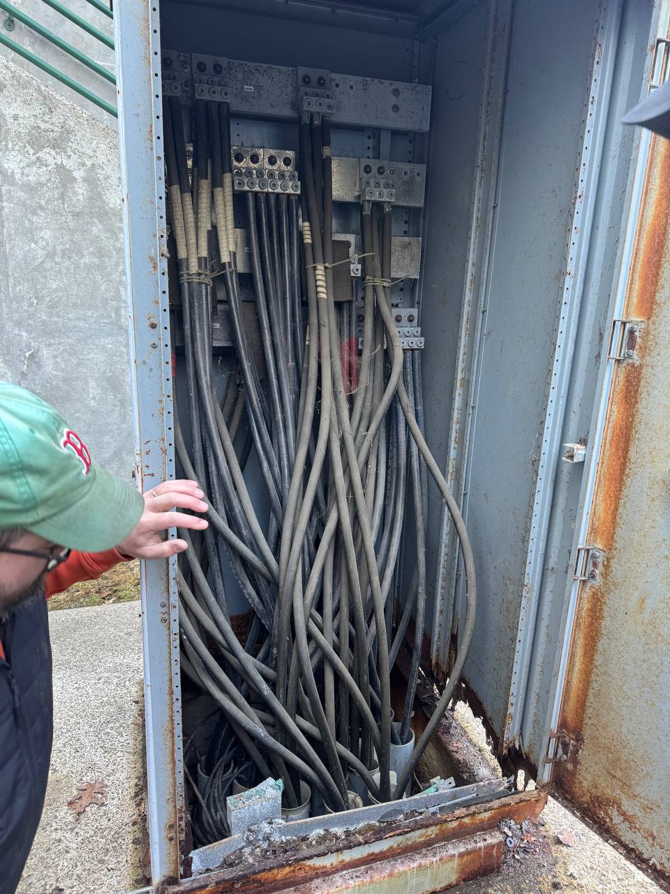 Interior of old combiner — corroded bus work and bundled conductors
