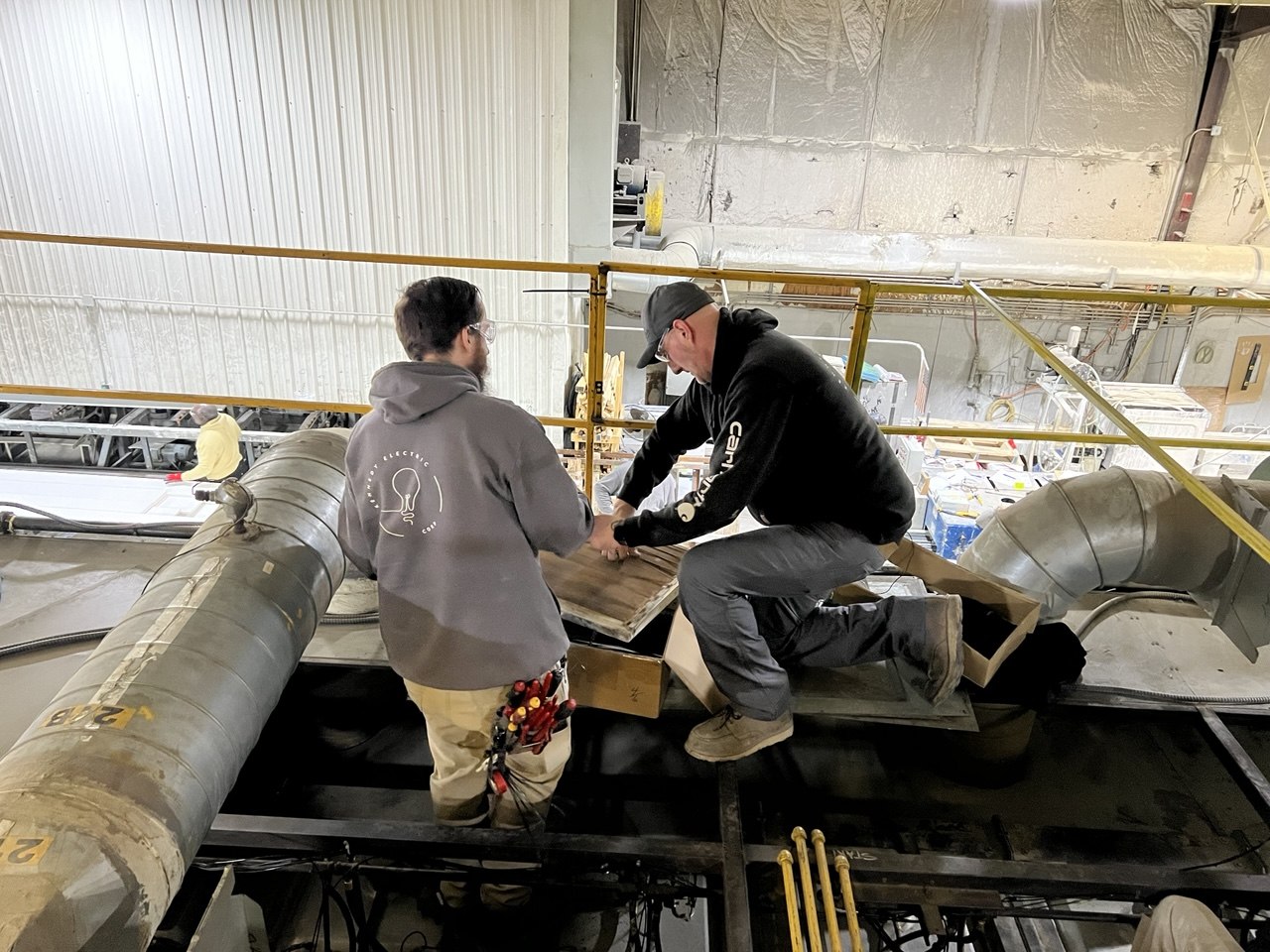 Post-fire emergency repair — two KEC techs on machine