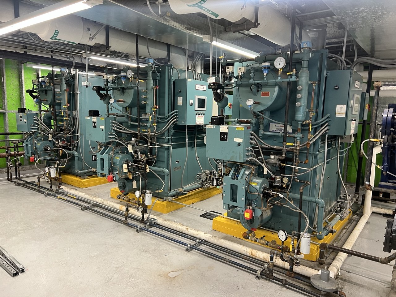 Hospital boiler room — three steam boilers with controls