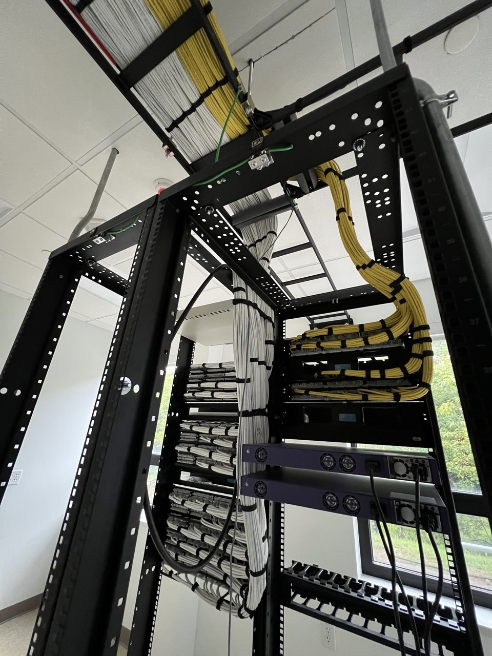 Completed server rack with yellow Cat6 patch cables